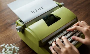 Blog post writing service with person typing on a typewriter and blog written on paper