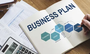 Custom business plan service with 'Business Plan' written on a book and person writing