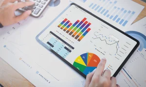 Keyword research and analysis with person using a tablet and displaying graphs