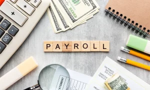 Payroll management service with 'Payroll' text surrounded by payroll accessories